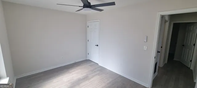 a view of a kitchen with a sink and wooden floor