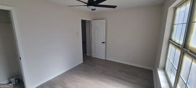a kitchen with stainless steel appliances a refrigerator and a wooden floor