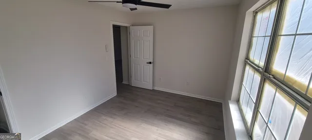 a kitchen with granite countertop a sink and a wooden floor