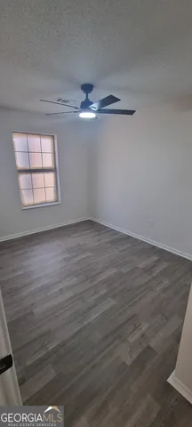 a view of a kitchen with refrigerator stove and cabinets