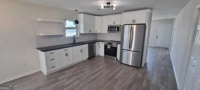 a view of a kitchen with a refrigerator
