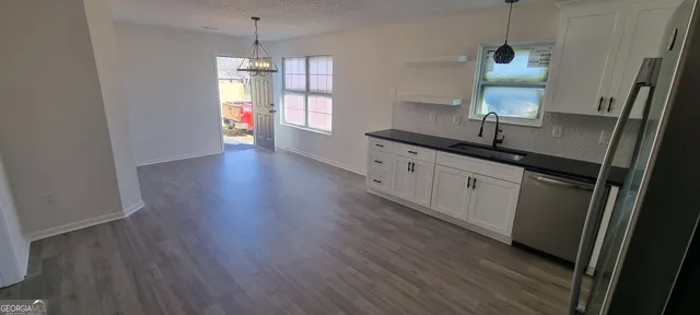 a view of room with window and wooden floor