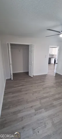 a view of backyard with wooden fence and large trees
