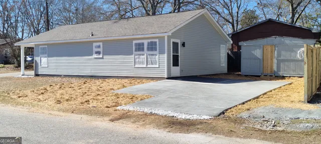 a view of house with backyard