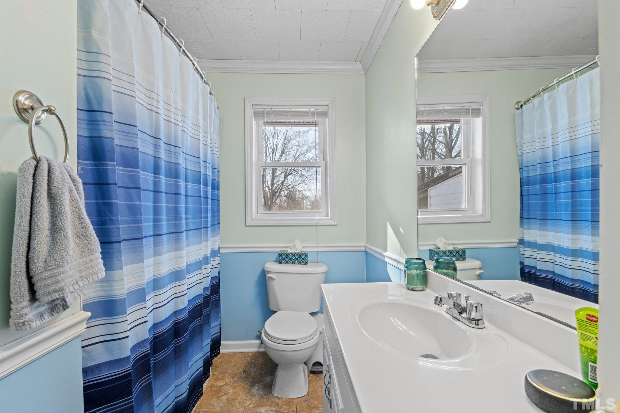 46 Layne Street Roxboro, NC 27573 - Photo 11 of 17 a bathroom with a sink toilet and shower