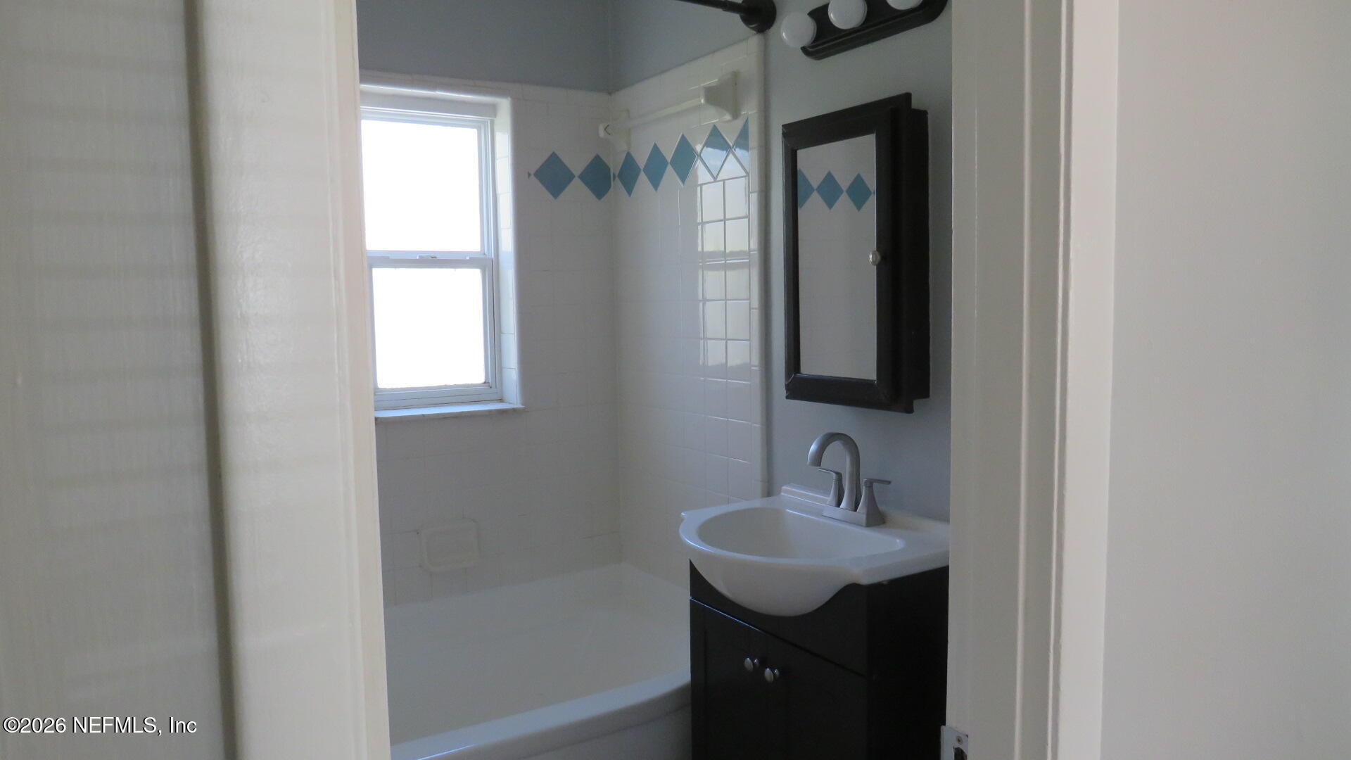 3412 Brockway Road Jacksonville, FL 32250 - Photo 8 of 16 a bathroom with a sink and a mirror