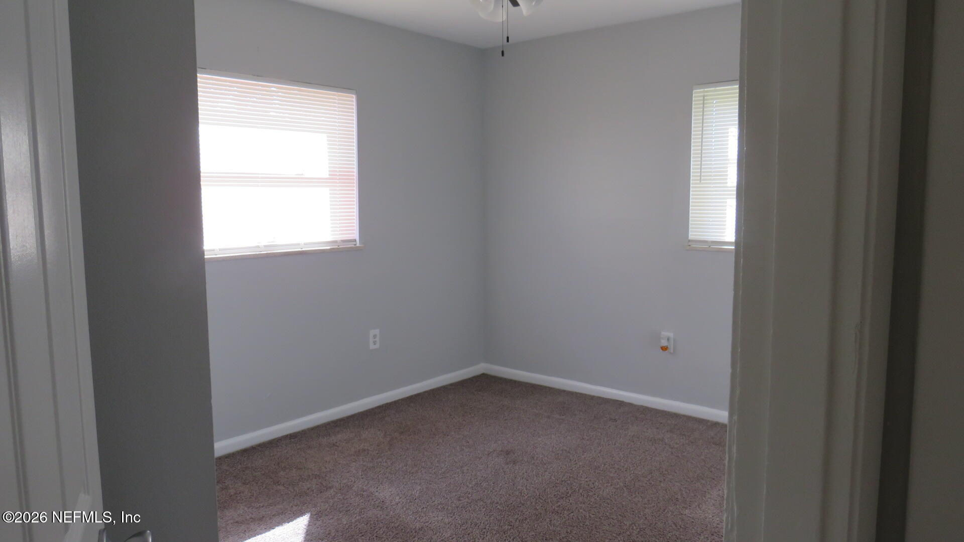 3412 Brockway Road Jacksonville, FL 32250 - Photo 9 of 16 an empty room with a window