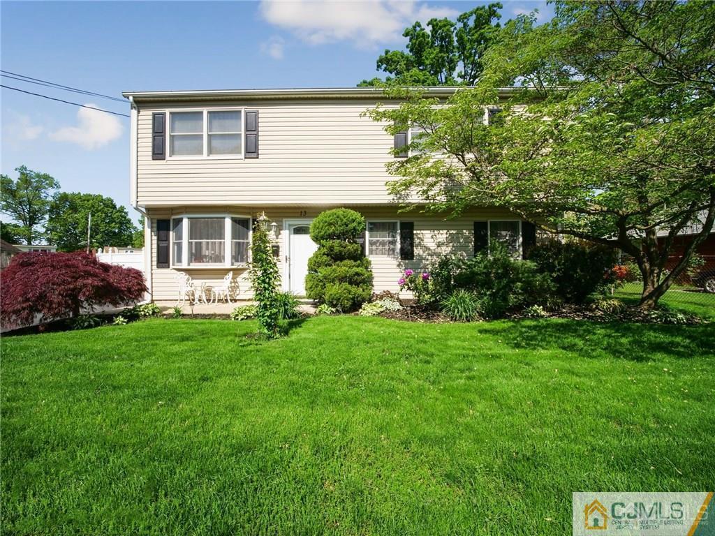 13 Stiles Road Edison, NJ 08817 - Photo 1 of 24 a front view of a house with a garden and plants