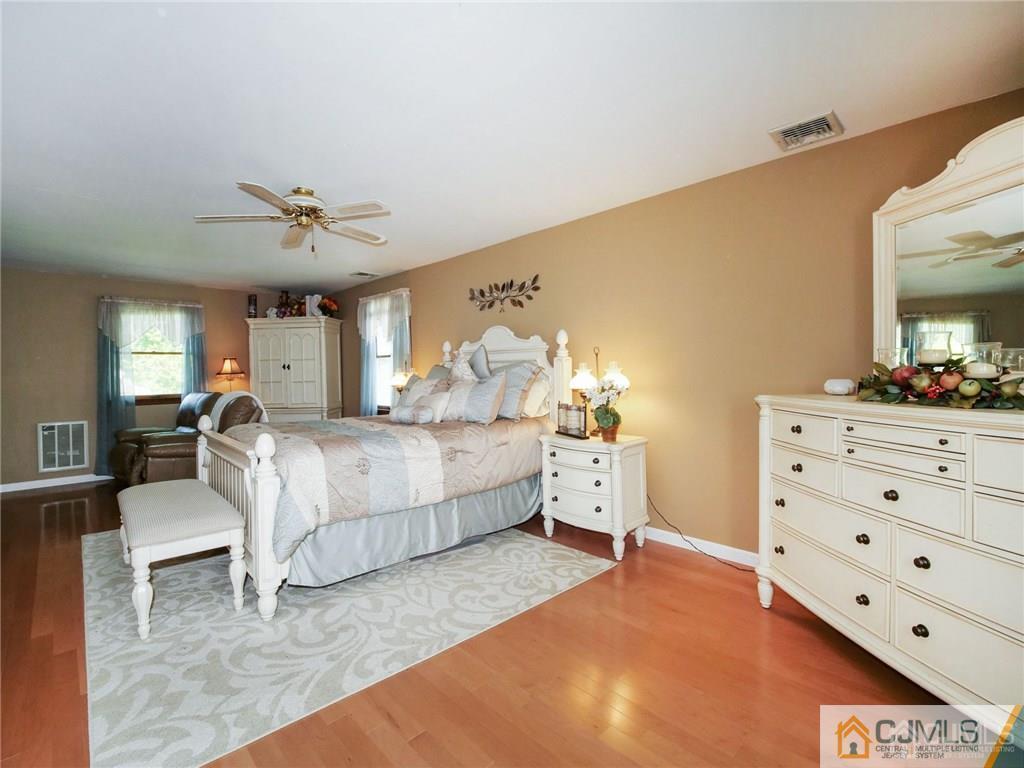 13 Stiles Road Edison, NJ 08817 - Photo 14 of 24 a bedroom with a bed and a chandelier