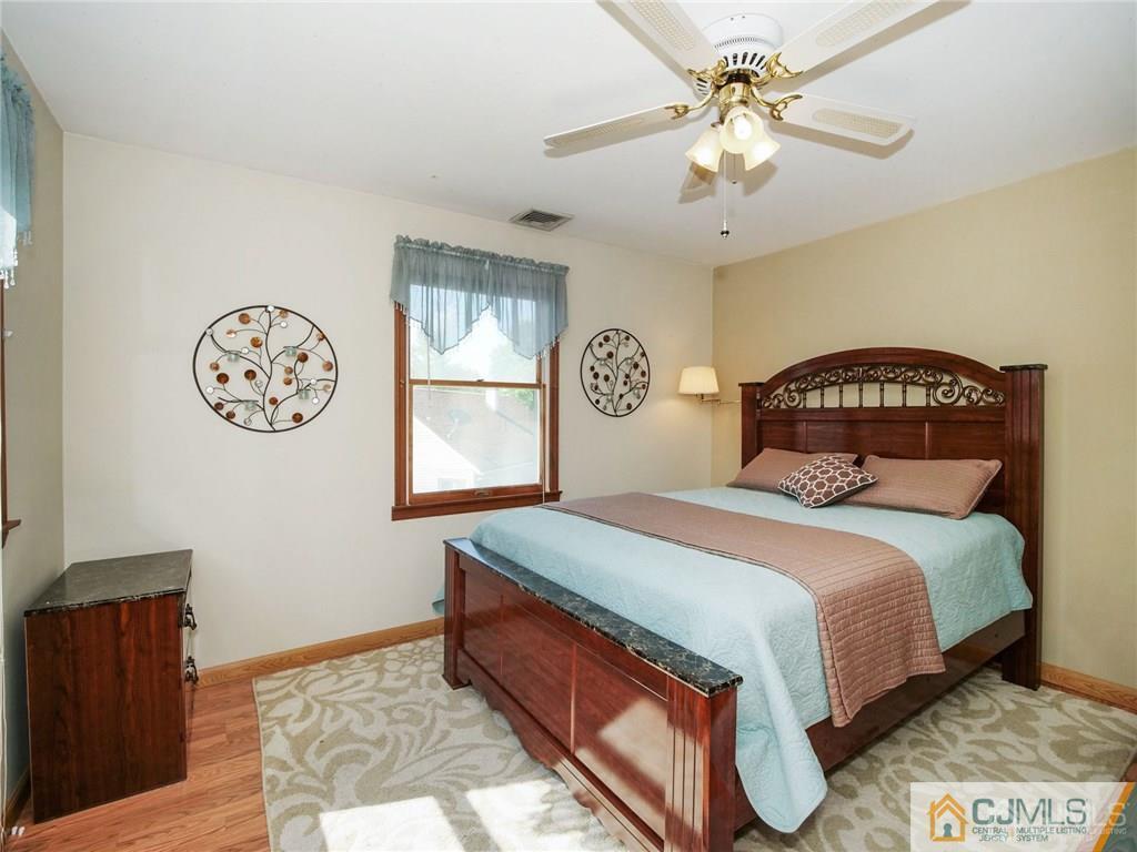 13 Stiles Road Edison, NJ 08817 - Photo 15 of 24 a bedroom with a bed and a chandelier