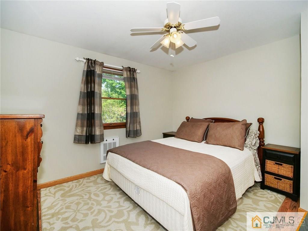13 Stiles Road Edison, NJ 08817 - Photo 16 of 24 a bedroom with a bed and a window