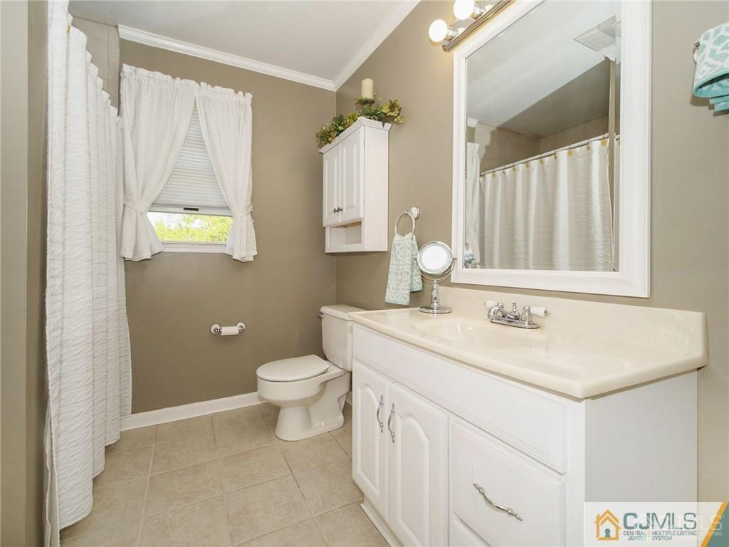 13 Stiles Road Edison, NJ 08817 - Photo 17 of 24 a bathroom with a sink and a toilet