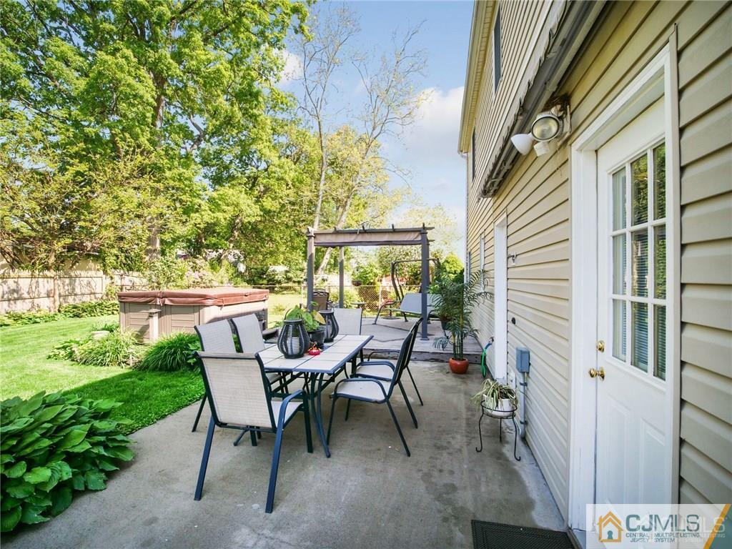 13 Stiles Road Edison, NJ 08817 - Photo 18 of 24 a view of a patio with table and chairs and potted plants