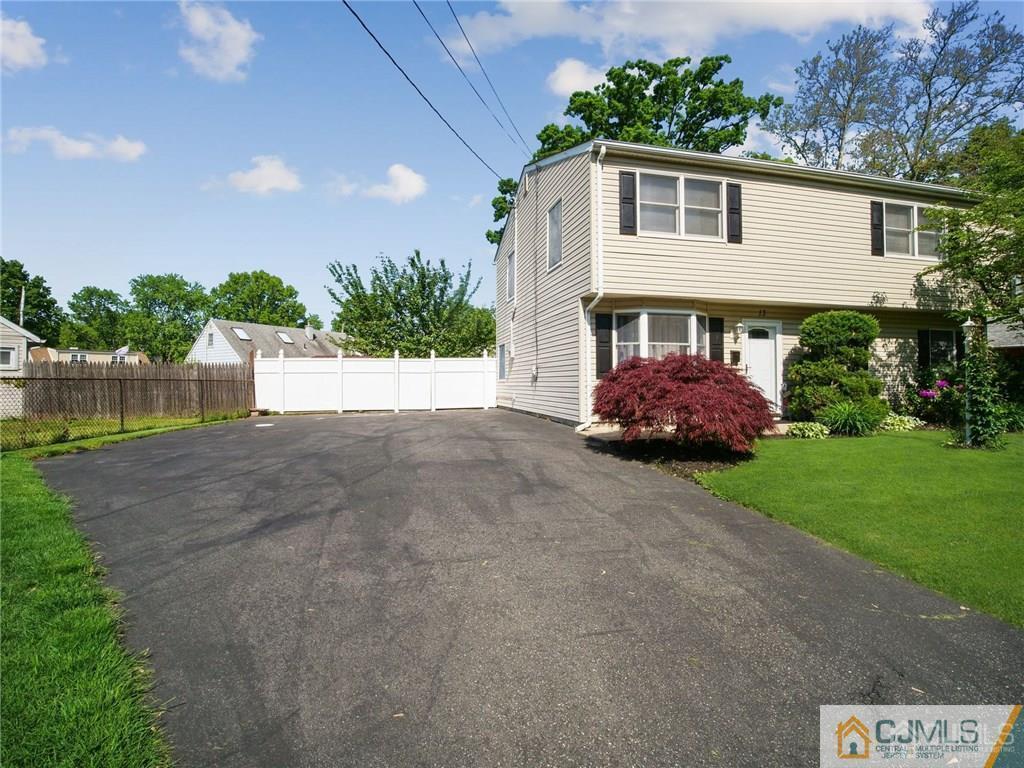 13 Stiles Road Edison, NJ 08817 - Photo 2 of 24 a front view of a house with a yard and garage