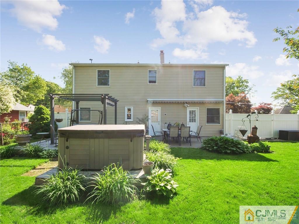 13 Stiles Road Edison, NJ 08817 - Photo 22 of 24 a view of a house with a backyard and sitting area