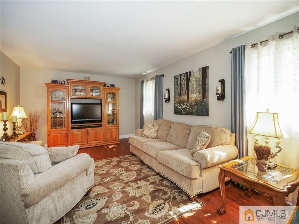 13 Stiles Road Edison, NJ 08817 - Photo 4 of 24 a living room with furniture and a flat screen tv