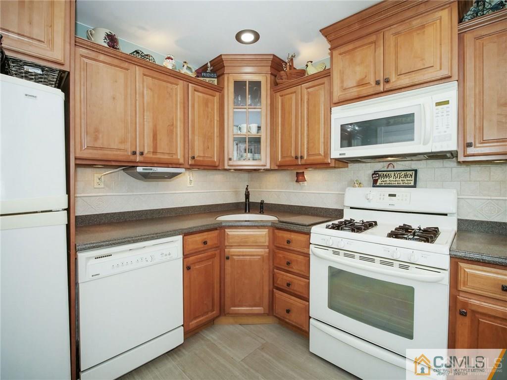 13 Stiles Road Edison, NJ 08817 - Photo 8 of 24 a kitchen with stainless steel appliances granite countertop a stove a sink and a microwave