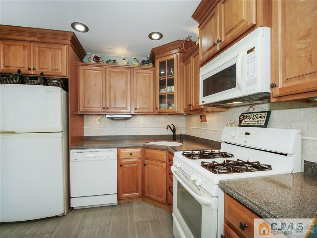 13 Stiles Road Edison, NJ 08817 - Photo 10 of 24 a kitchen with stainless steel appliances granite countertop a stove a sink and a refrigerator