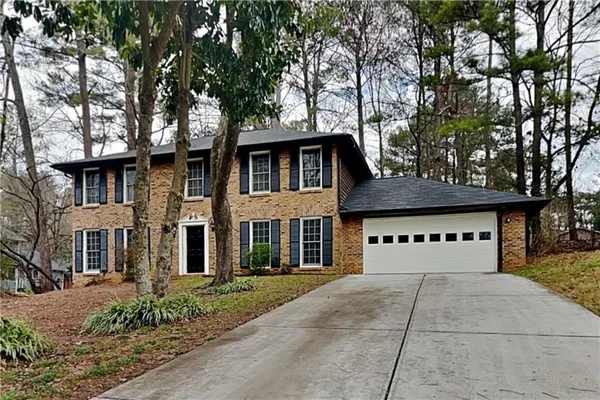 front view of a house with a tree