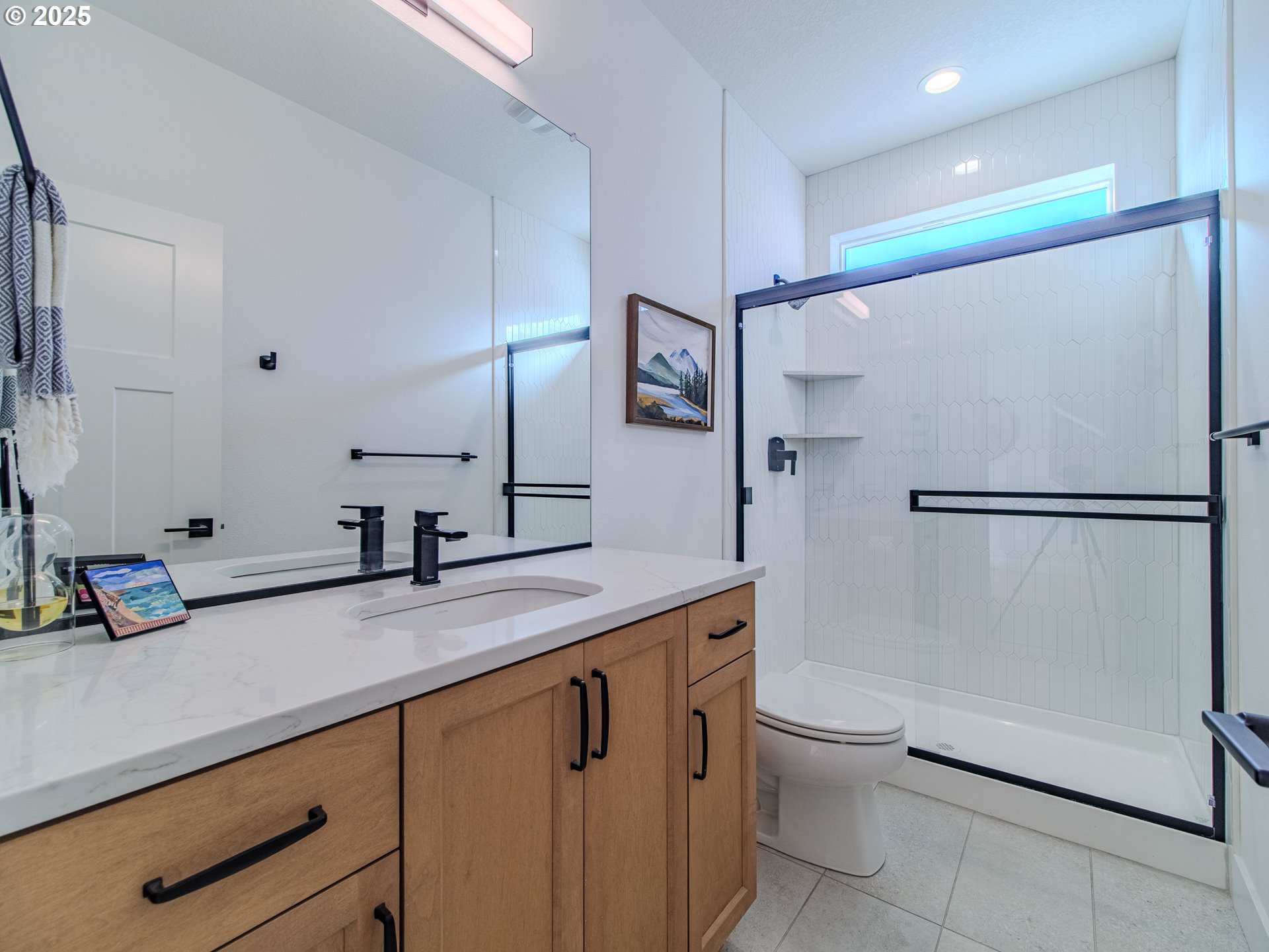8588 Summit Court Portland, OR 97225 - Photo 18 of 22 a bathroom with a sink a toilet a mirror and shower