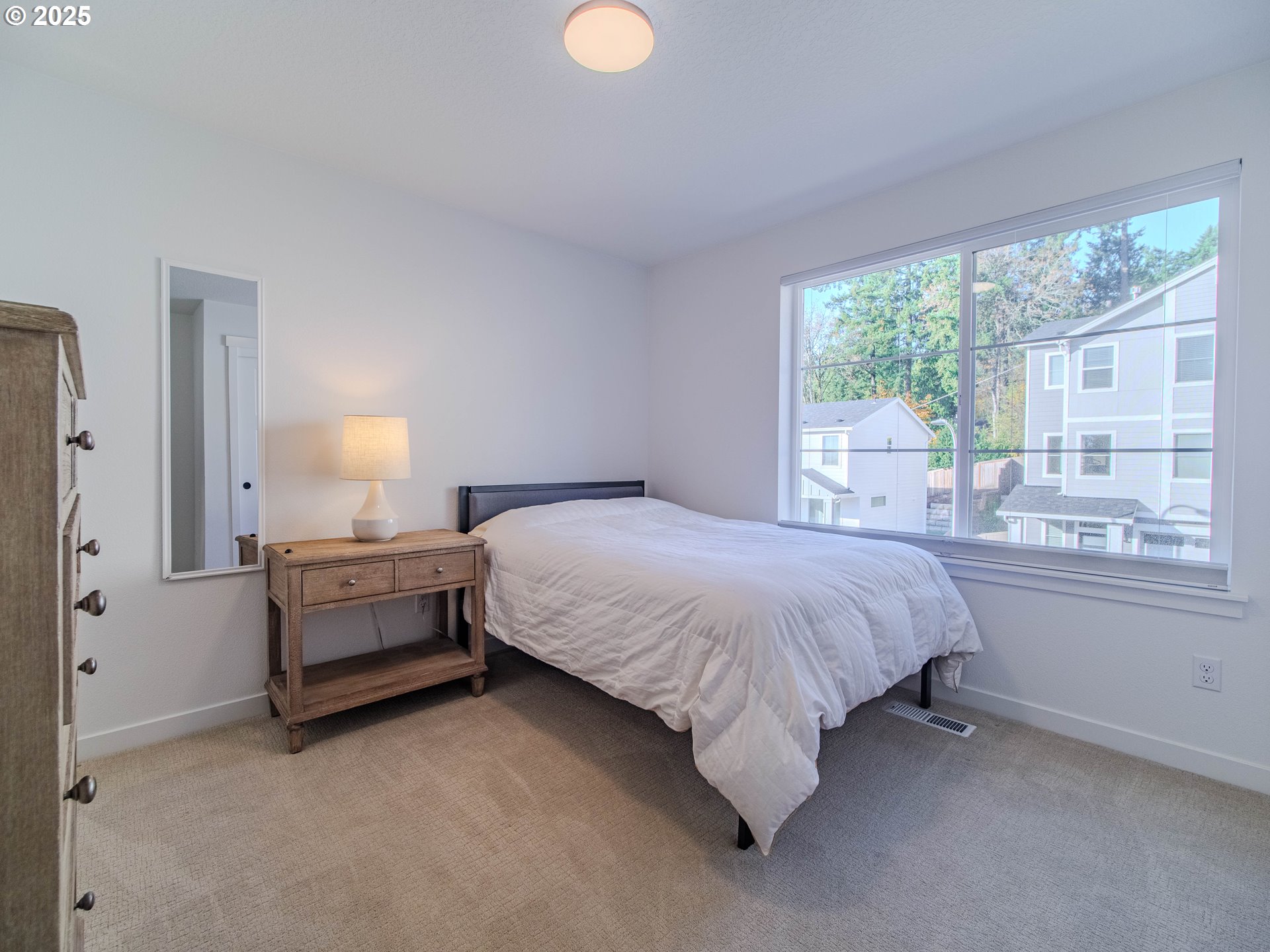 8588 Summit Court Portland, OR 97225 - Photo 20 of 22 a spacious bedroom with a bed and window