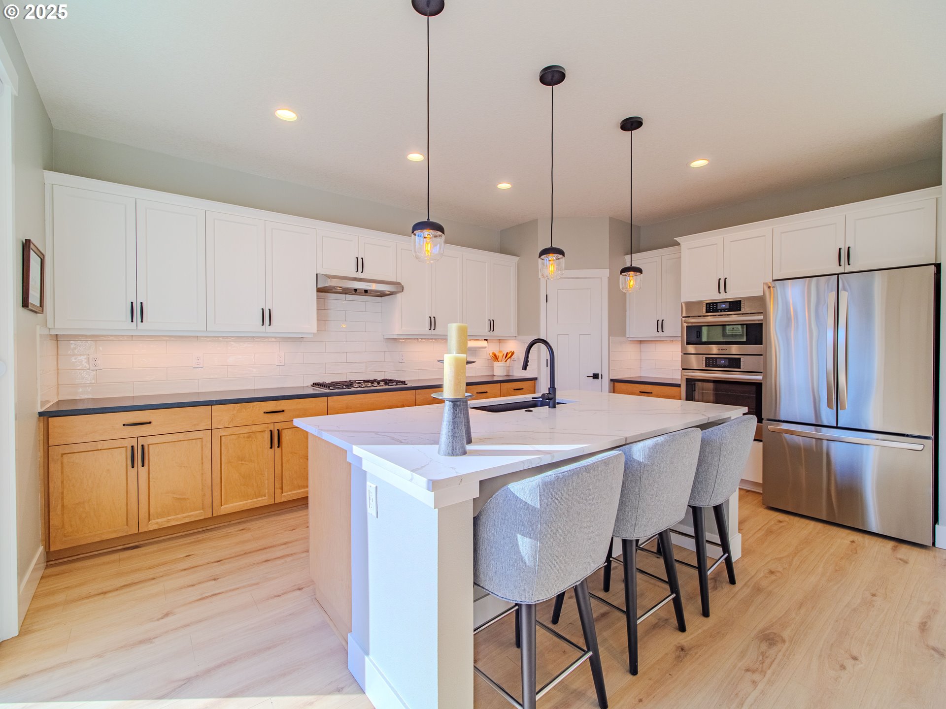 8588 Summit Court Portland, OR 97225 - Photo 4 of 22 a kitchen with stainless steel appliances granite countertop a sink a stove a refrigerator and island with wooden floor