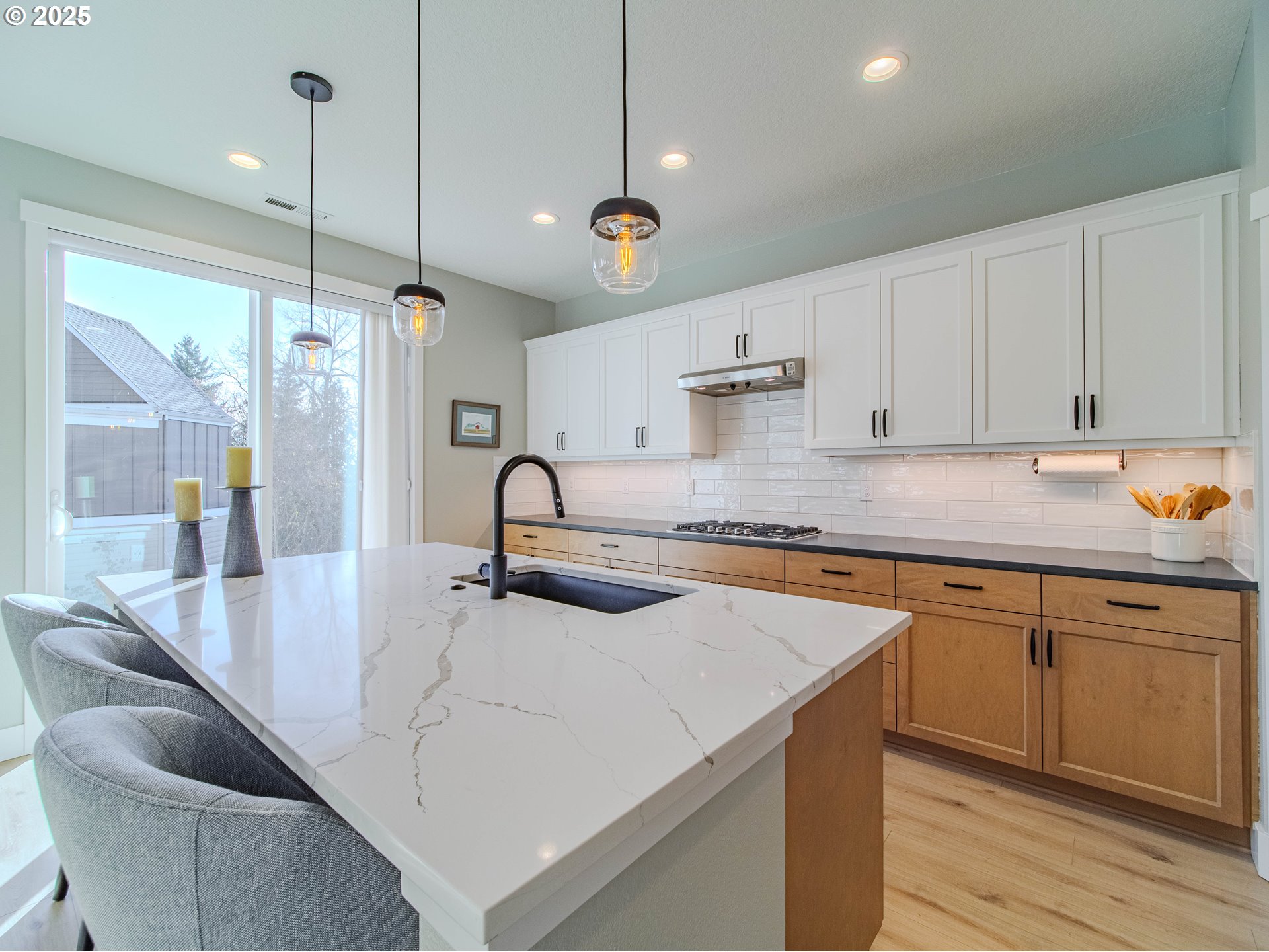 8588 Summit Court Portland, OR 97225 - Photo 6 of 22 a kitchen with stainless steel appliances granite countertop a sink a stove and a wooden floors