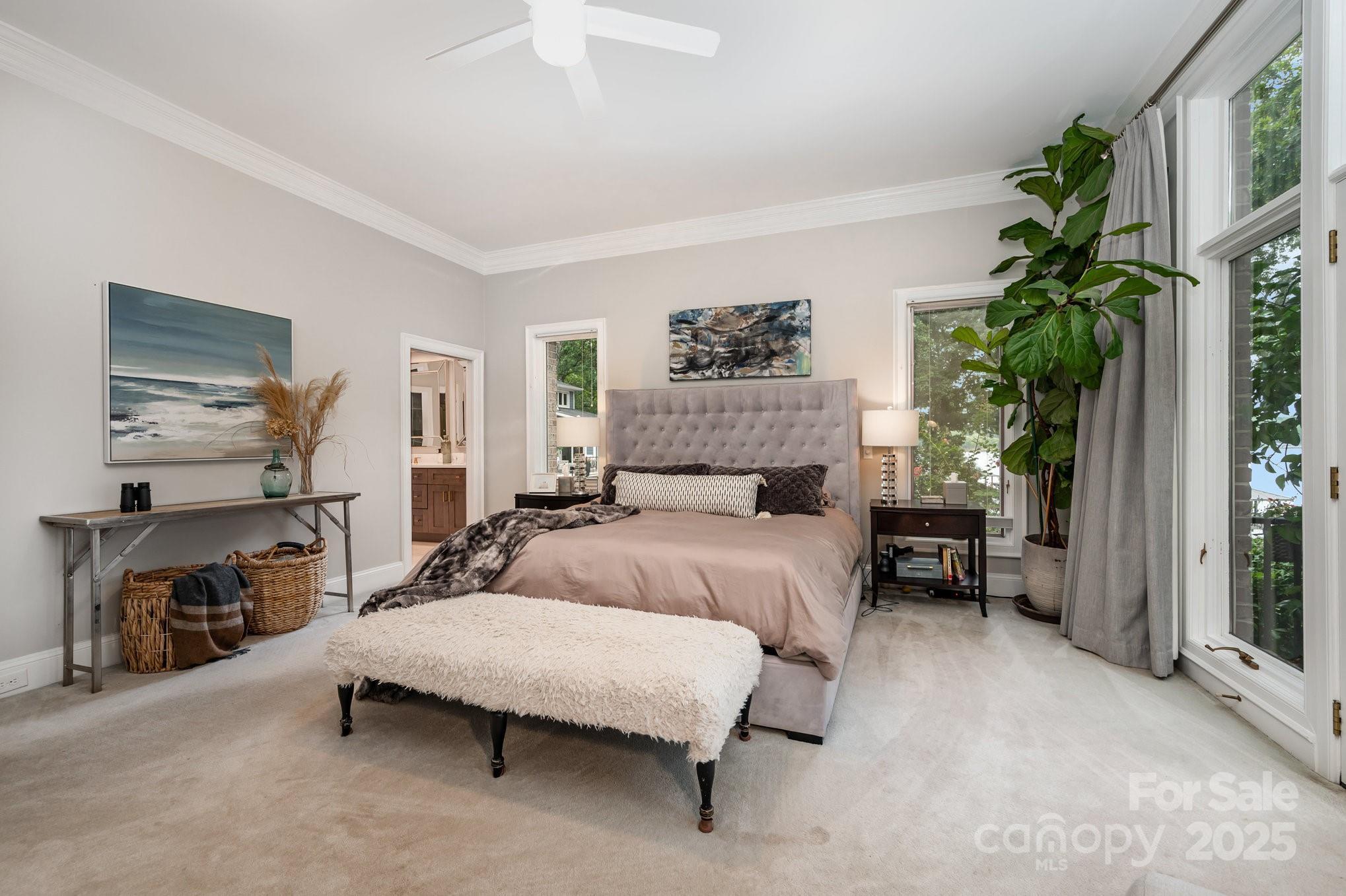 16133 North Point Road Huntersville, NC 28078 - Photo 20 of 48 a bedroom with a large bed and a potted plant