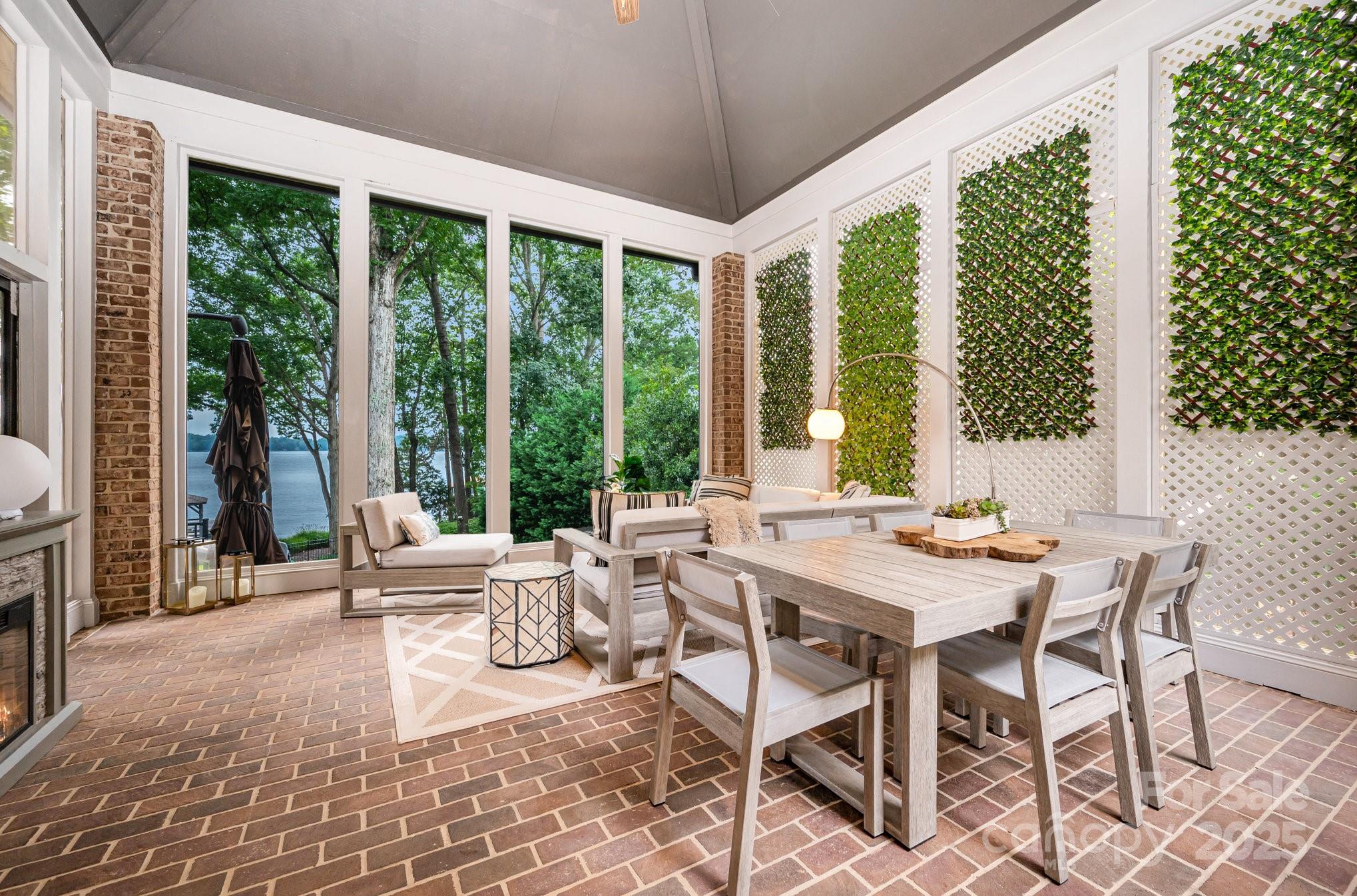 16133 North Point Road Huntersville, NC 28078 - Photo 30 of 48 a view of a dining room with furniture large windows and wooden floor