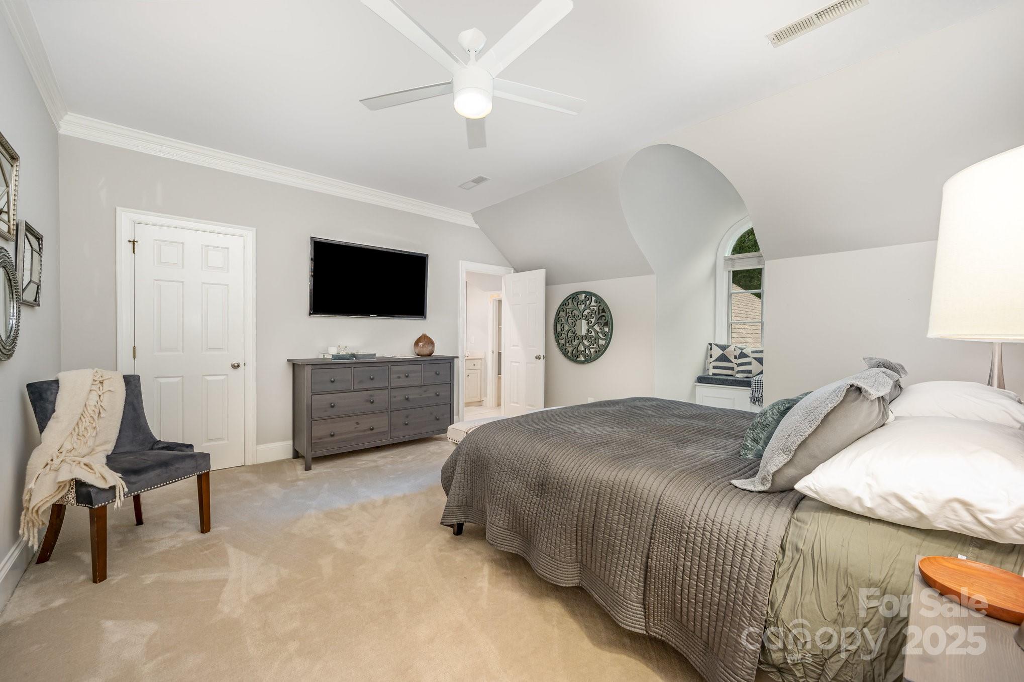 16133 North Point Road Huntersville, NC 28078 - Photo 34 of 48 a bedroom with a bed window and a flat screen tv