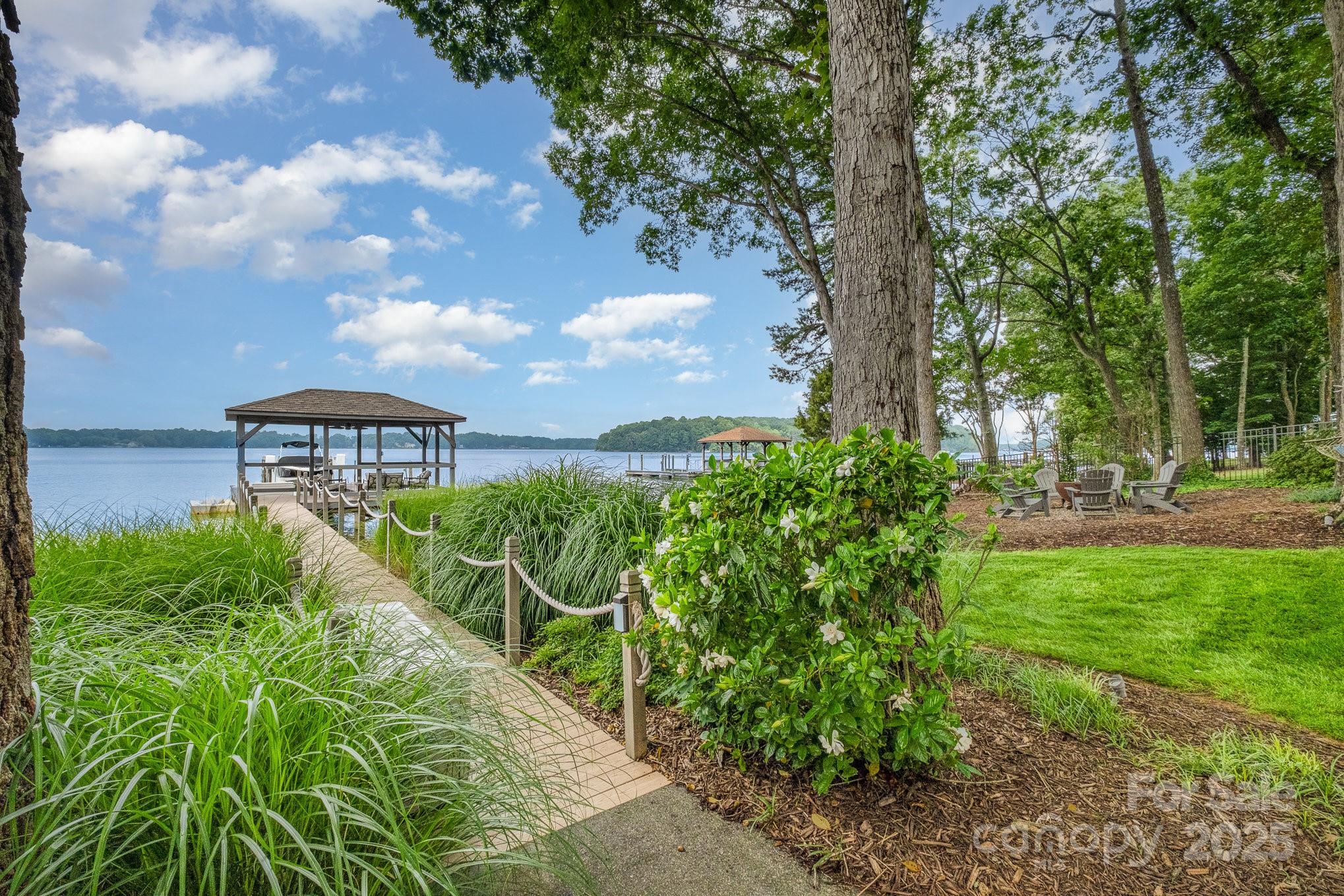 16133 North Point Road Huntersville, NC 28078 - Photo 4 of 48 a view of a garden with plants and large trees