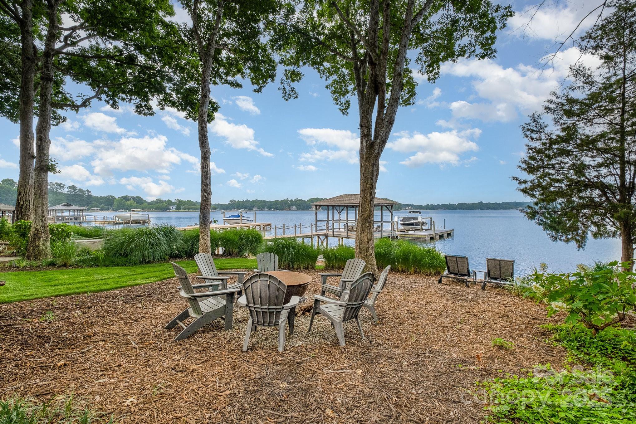 16133 North Point Road Huntersville, NC 28078 - Photo 42 of 48 a view of a patio with a table chairs and a fire pit