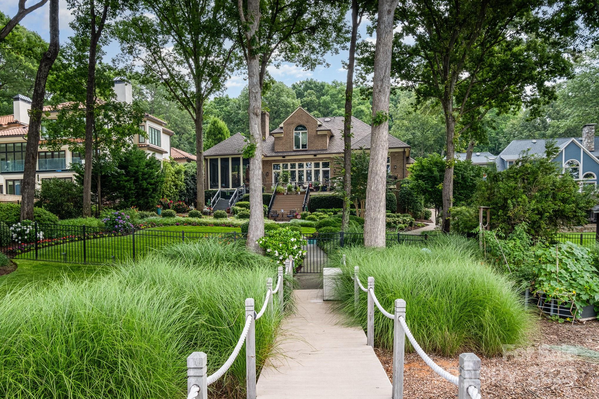 16133 North Point Road Huntersville, NC 28078 - Photo 43 of 48 a view of a garden with plants and large trees
