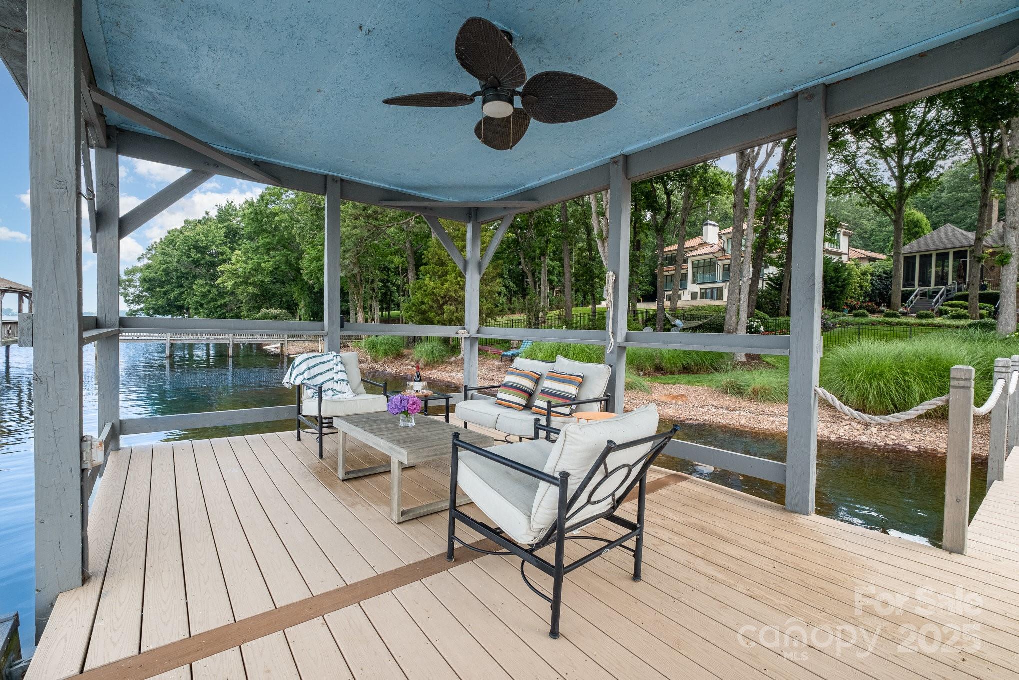16133 North Point Road Huntersville, NC 28078 - Photo 45 of 48 a view of a patio with table and chairs floor to ceiling window with wooden floor