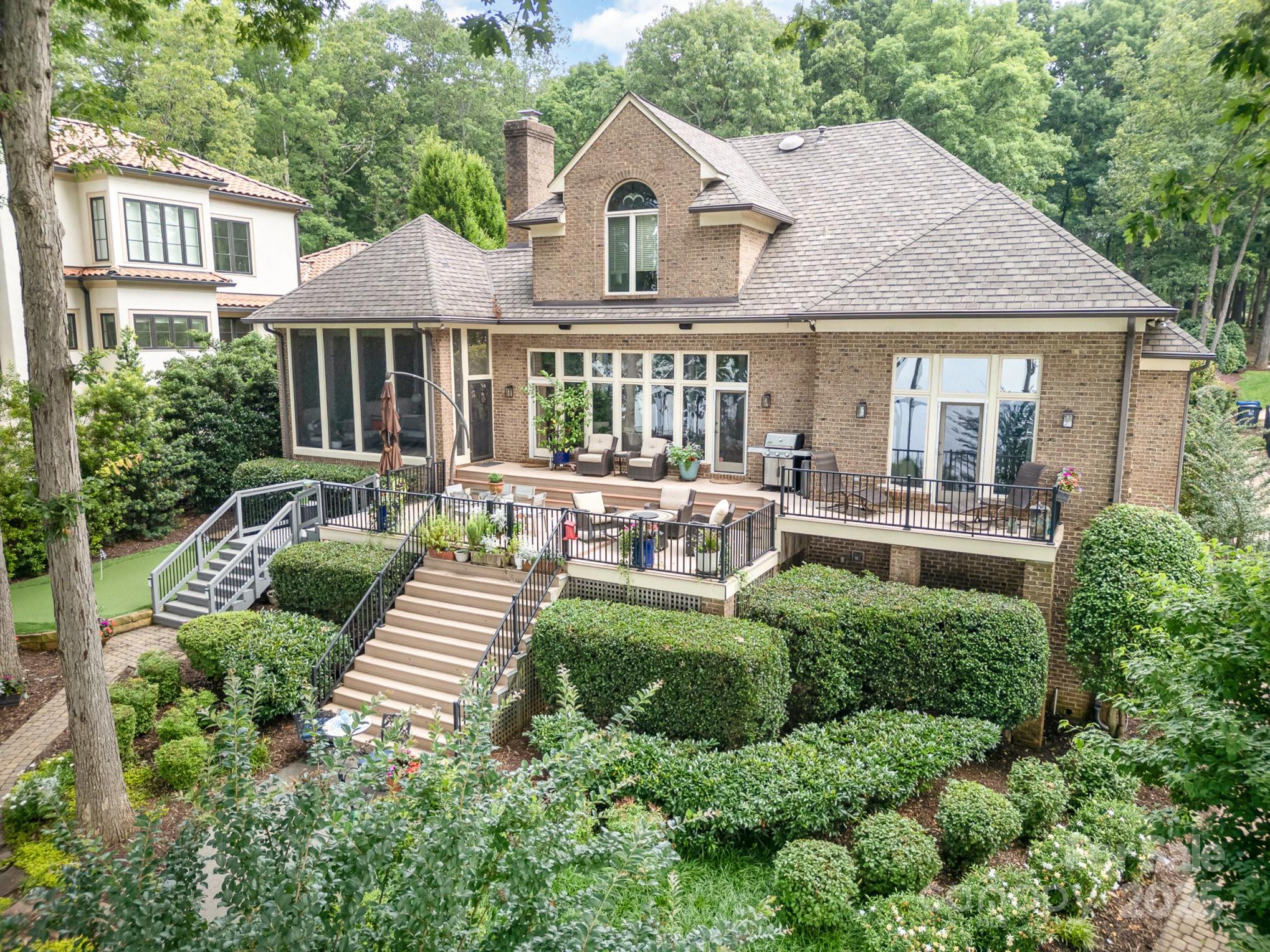 16133 North Point Road Huntersville, NC 28078 - Photo 7 of 48 a front view of a house with a yard table and chairs