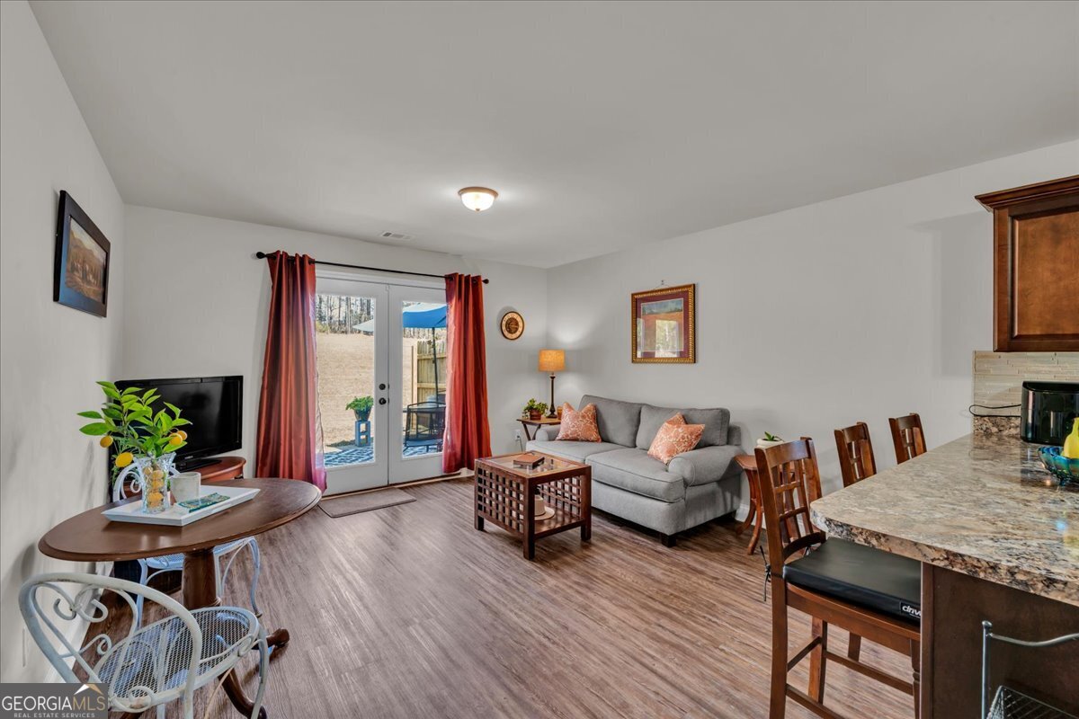 773 Weldon Road Forsyth, GA 31029 - Photo 13 of 37 a living room with furniture and wooden floor