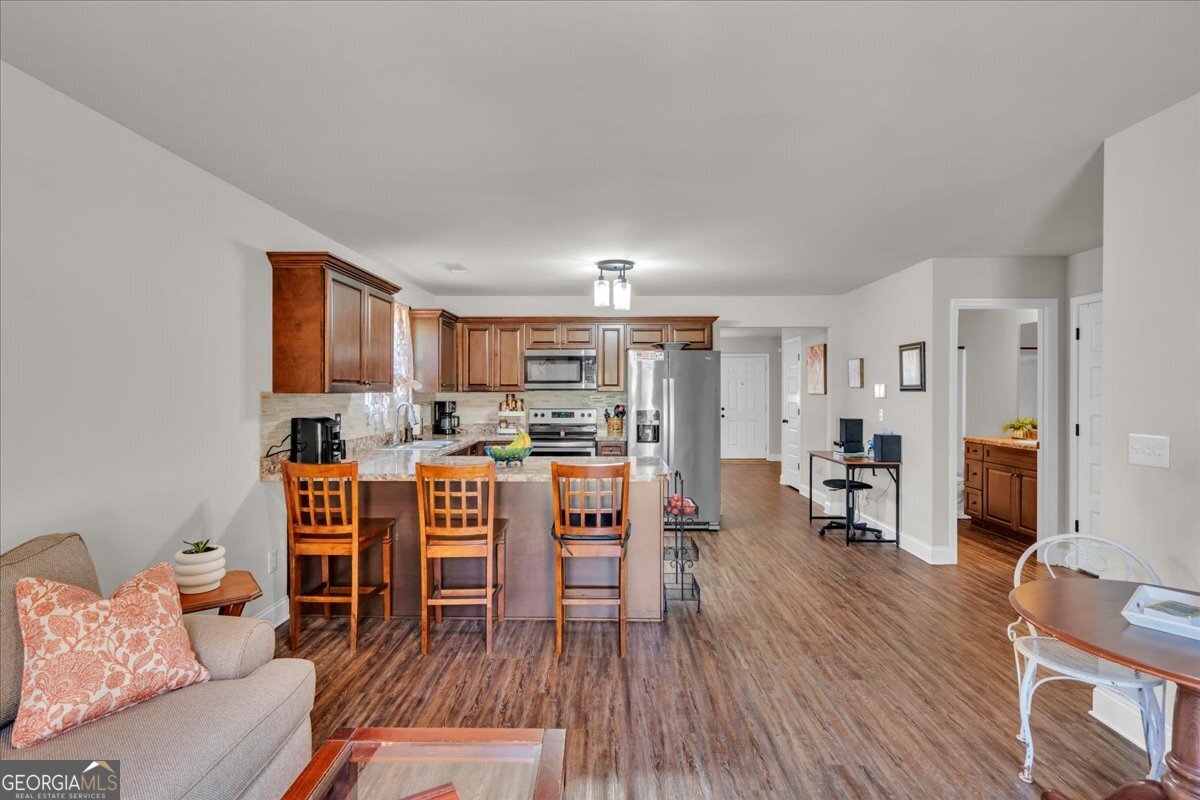 773 Weldon Road Forsyth, GA 31029 - Photo 14 of 37 a living room with furniture and a wooden floor