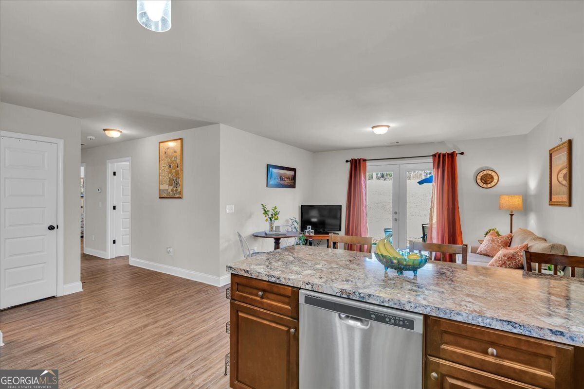 773 Weldon Road Forsyth, GA 31029 - Photo 16 of 37 a kitchen with granite countertop a sink and a wooden floor