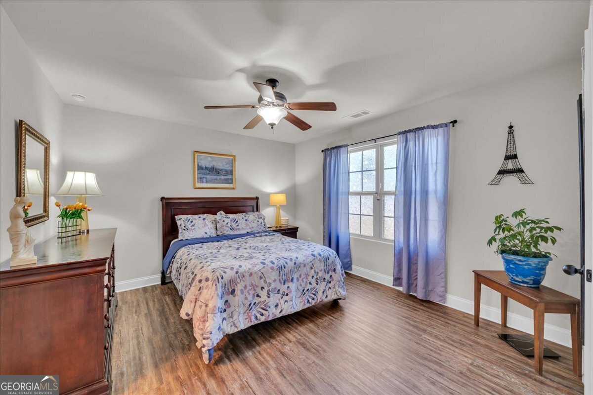 773 Weldon Road Forsyth, GA 31029 - Photo 17 of 37 a bedroom with a bed table and a window