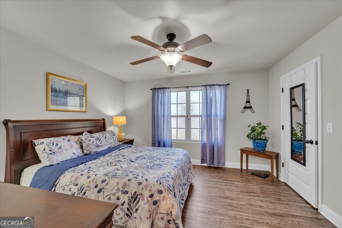 773 Weldon Road Forsyth, GA 31029 - Photo 18 of 37 a bedroom with a large bed and a window