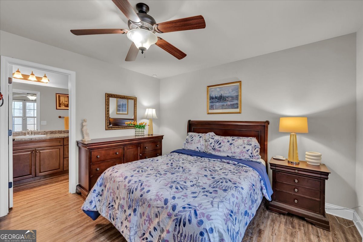 773 Weldon Road Forsyth, GA 31029 - Photo 19 of 37 a bedroom with a bed and wooden floor