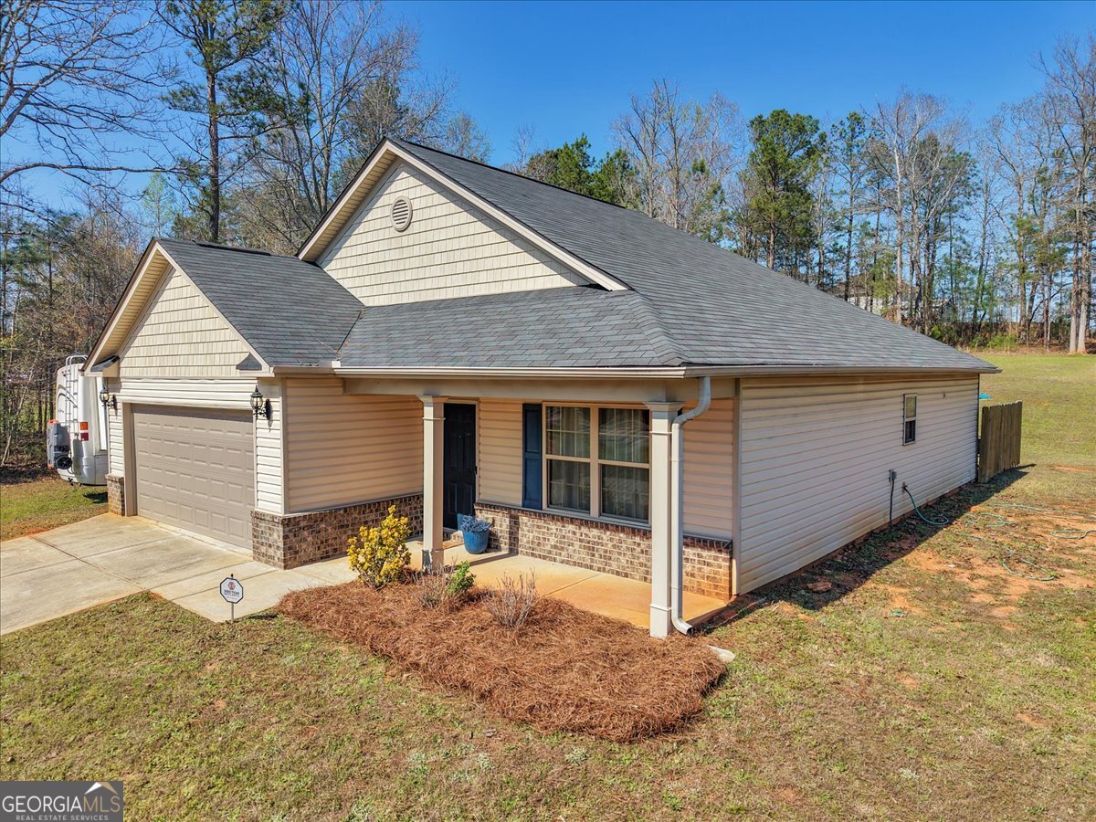 773 Weldon Road Forsyth, GA 31029 - Photo 2 of 37 a view of a house with a yard and large tree