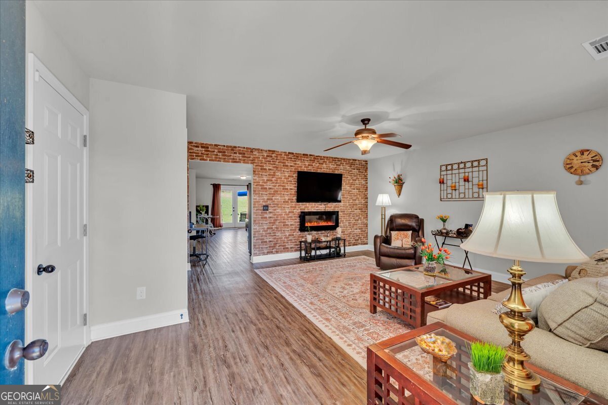 773 Weldon Road Forsyth, GA 31029 - Photo 3 of 37 a living room with furniture and flat screen tv