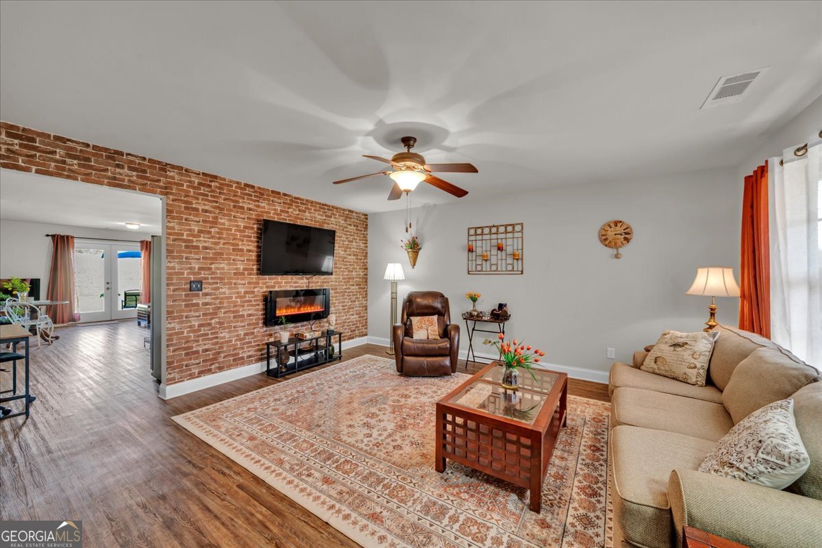 773 Weldon Road Forsyth, GA 31029 - Photo 4 of 37 a living room with furniture and a flat screen tv