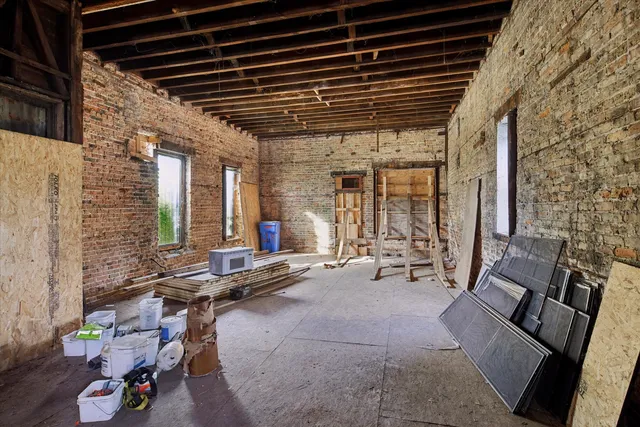 a living room with patio furniture and a large window