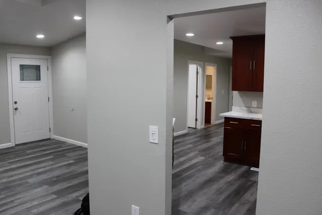 a view of hallway with wooden floor
