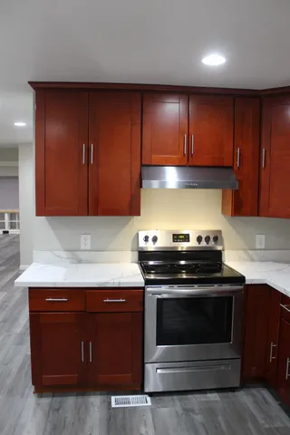 a stove top oven sitting inside of a kitchen
