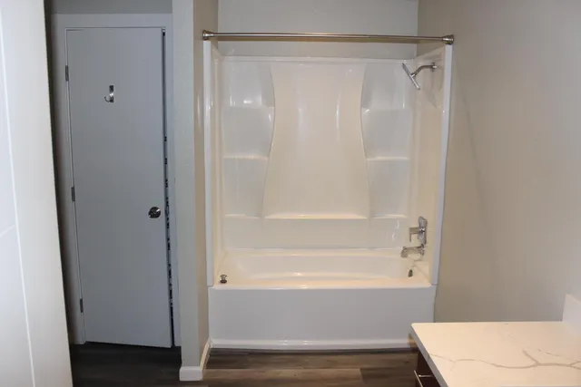 a bathroom with a bathtub and a shower