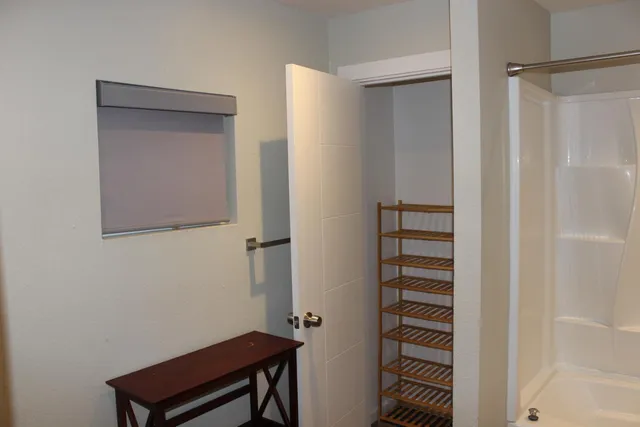 a view of a porch with two chairs and a potted plant