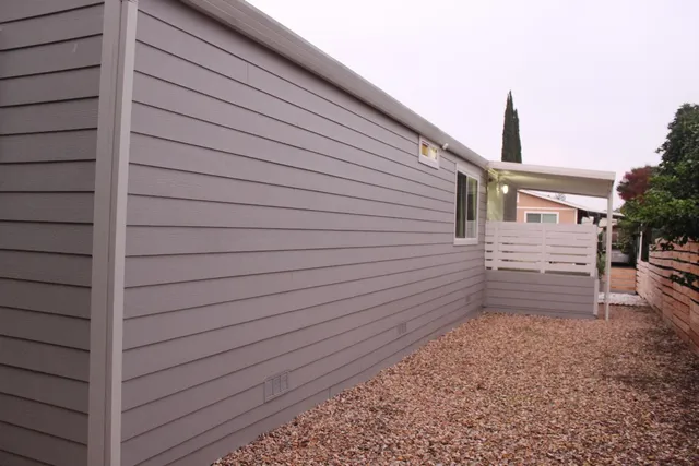 a view of a house with a yard and a chair